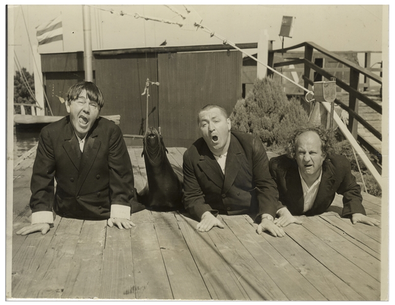 Moe Howard Personally Owned 10'' x 7.5'' Glossy Publicity Photo From 1939 in Atlantic City, With Curly, Moe & Larry Mimicking a Seal -- Photo Printed to Board, Very Good Condition